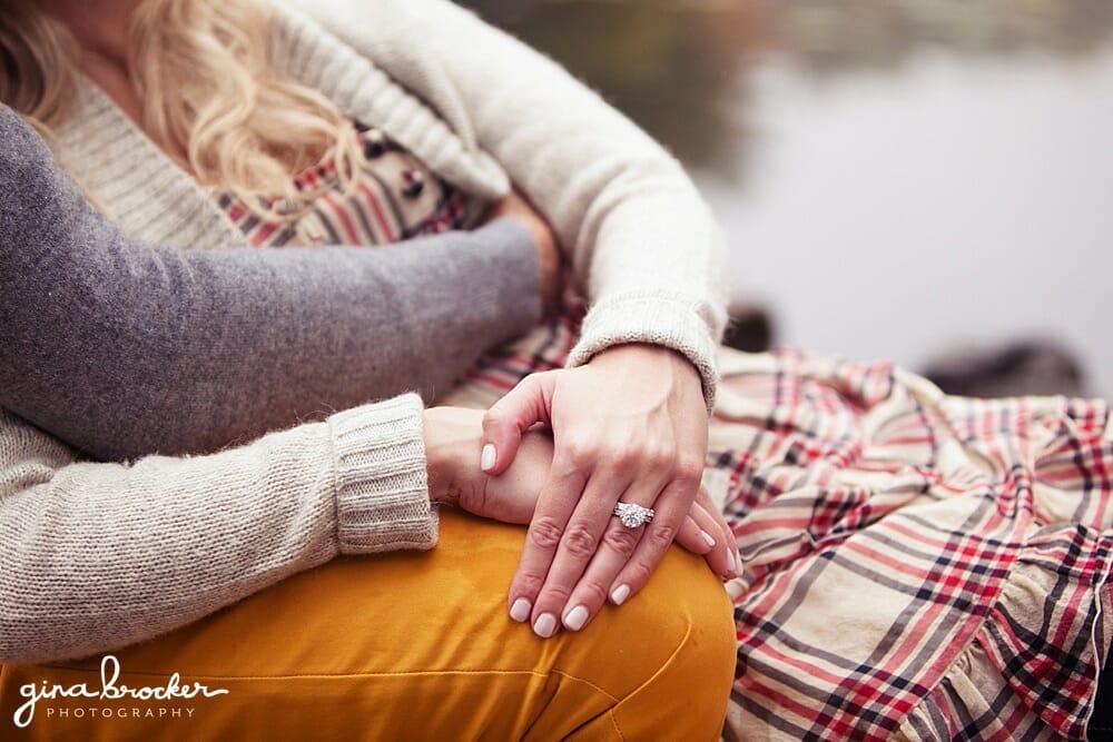 A beautiful diamond engagement ring detail taken while the couple is cuddling during their boston engagement session