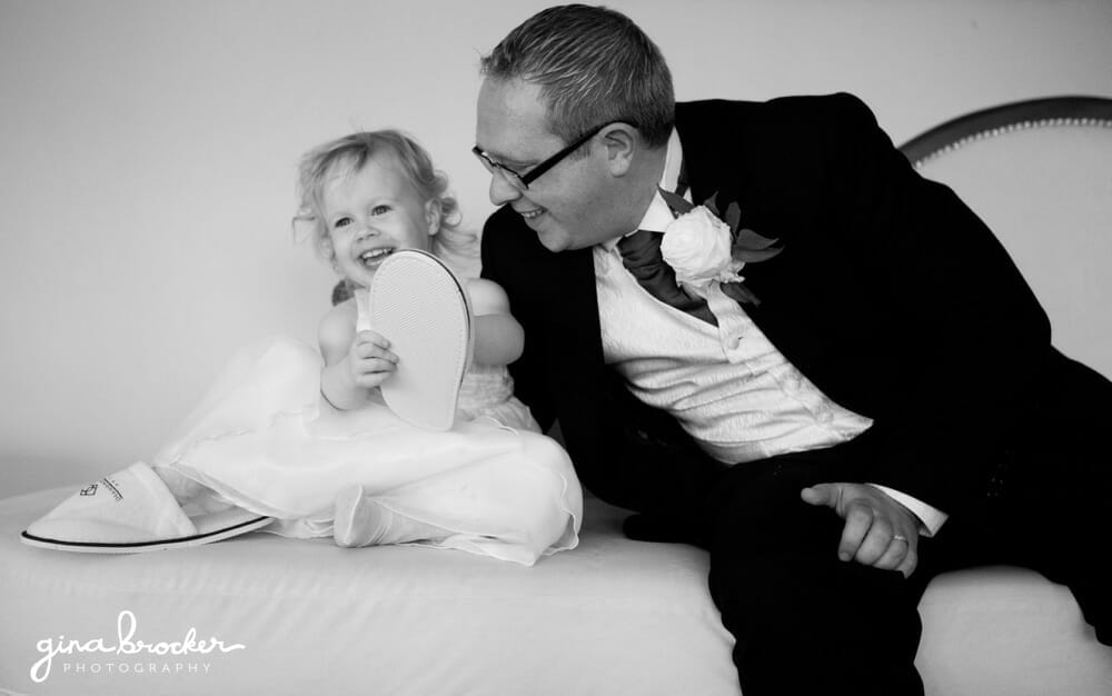 Groomsmen laughs with Flower Girls