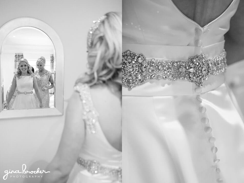 Bride puts on a classic wedding dress with silver accents for her classic winter wedding