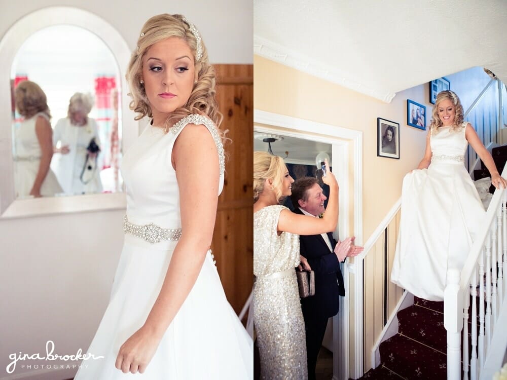 Bride walks down the stairs to her father wearing a classic winter wedding dress
