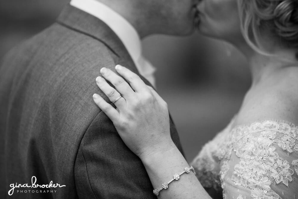 Bride and Groom kiss, wedding ring detail