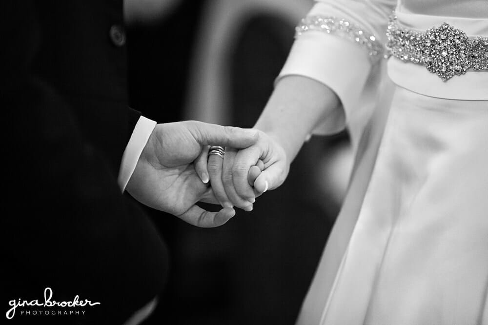 Bride and groom exchange rings during their wedding ceremony