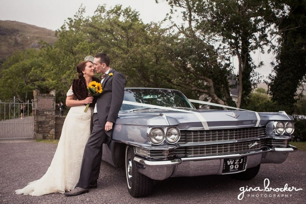 Bride and Groom kiss by their Cadillac