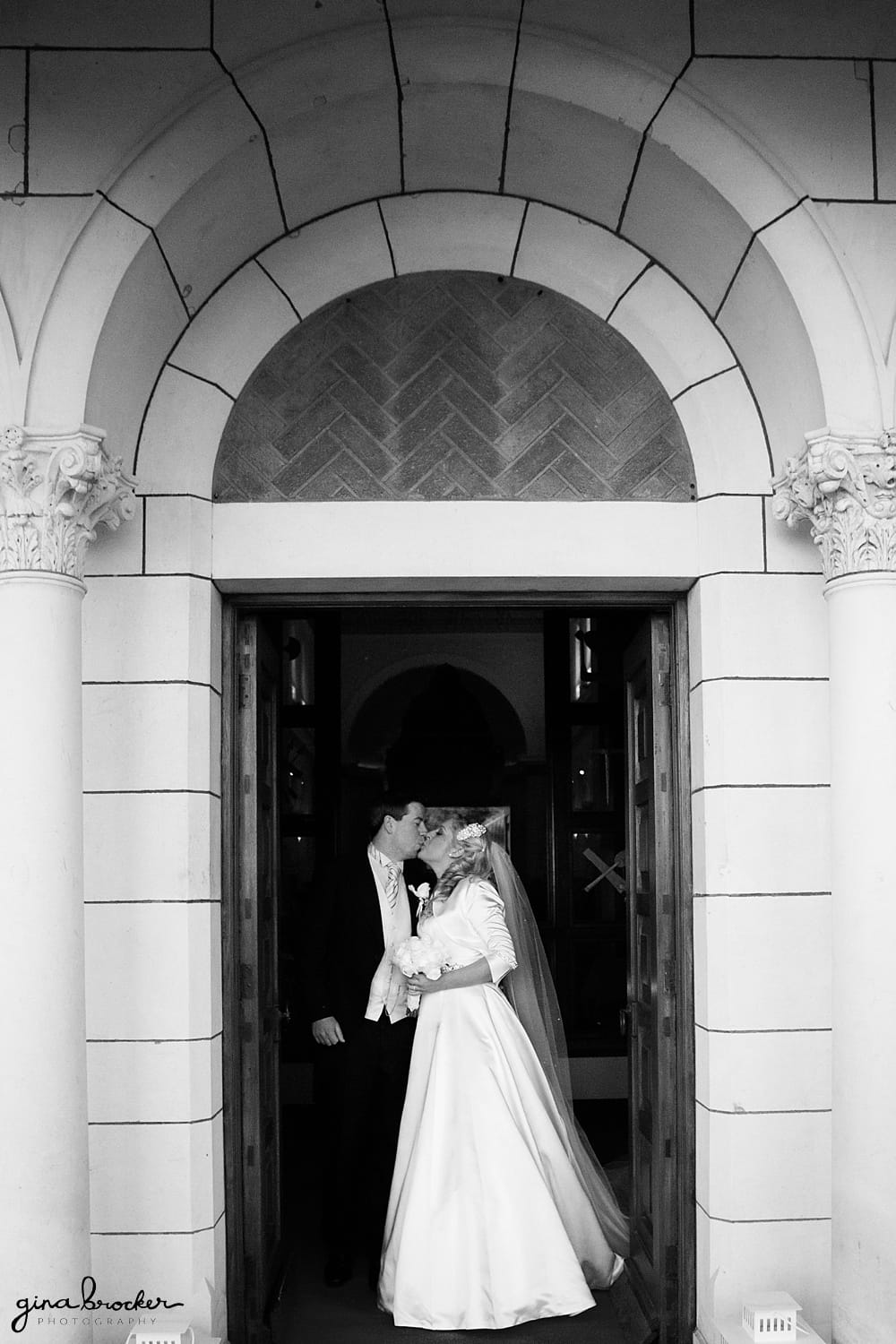 Bride and Groom kiss as they walk out of the church after their ceremony