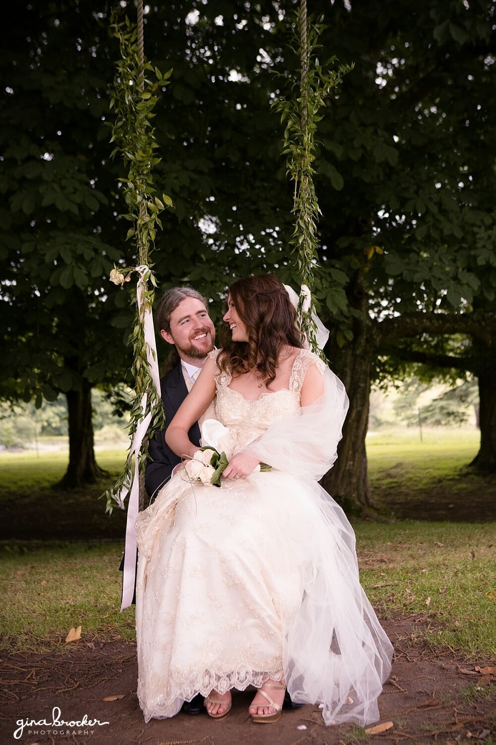 Bride and Groom cuddle on an ivy swing