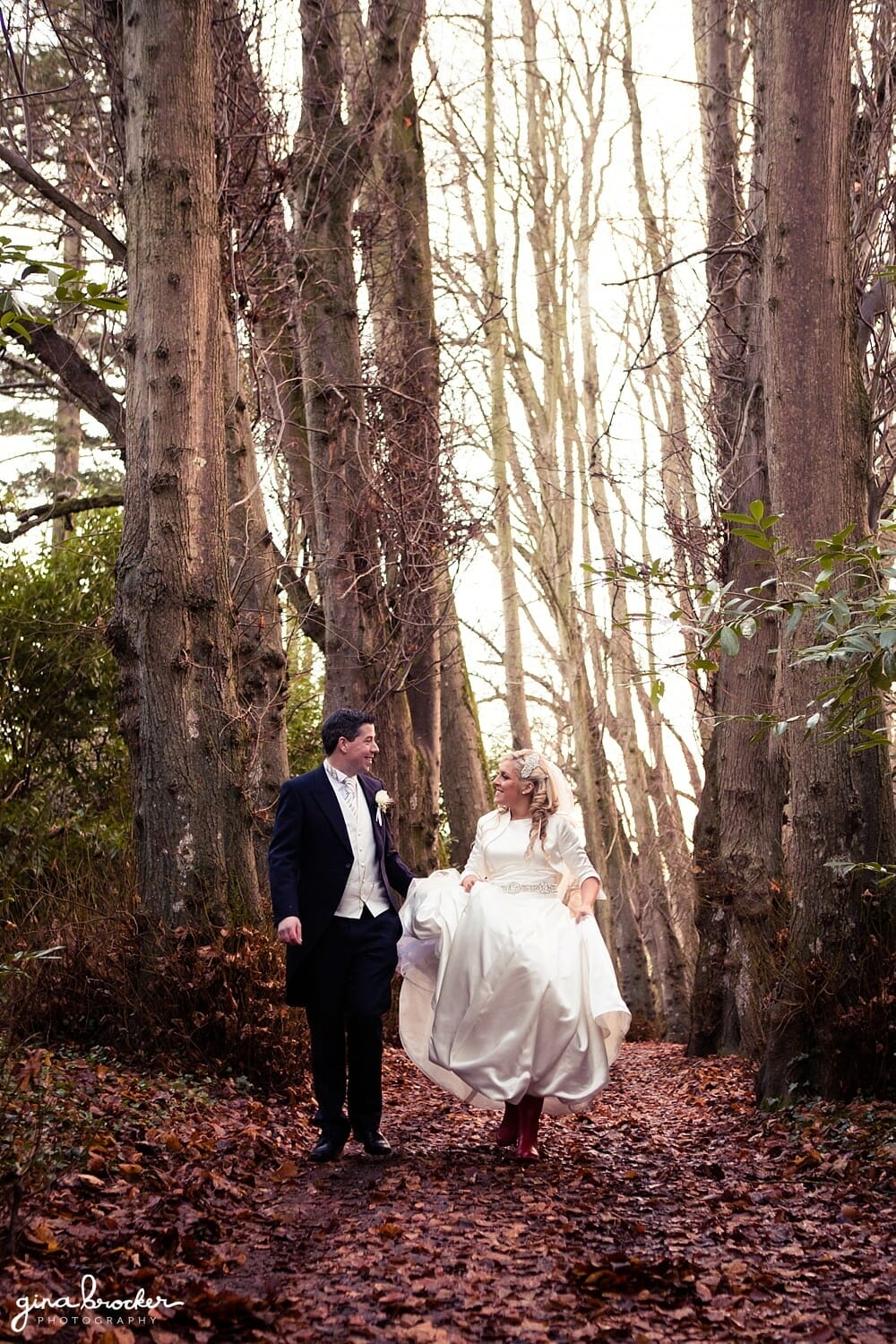 Classic winter wedding bride and groom walking in the woods