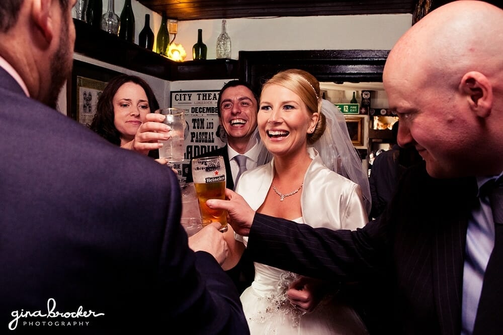 Bride and Groom celebrate in a pub Bride and Groom with friends at drinks reception