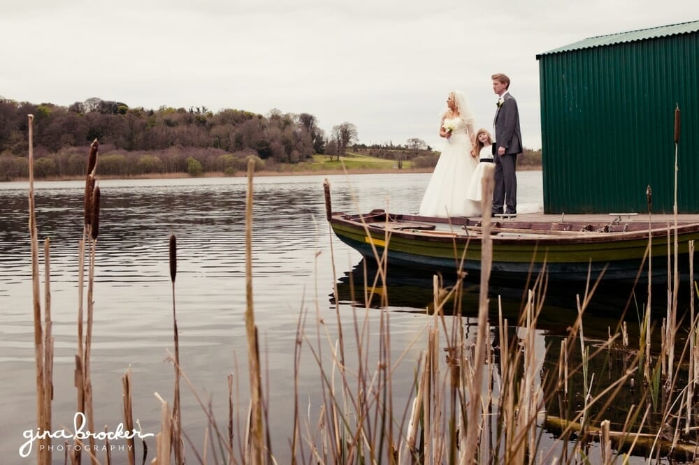 Bride and groom with daughter by lake natural family wedding portrait at lake