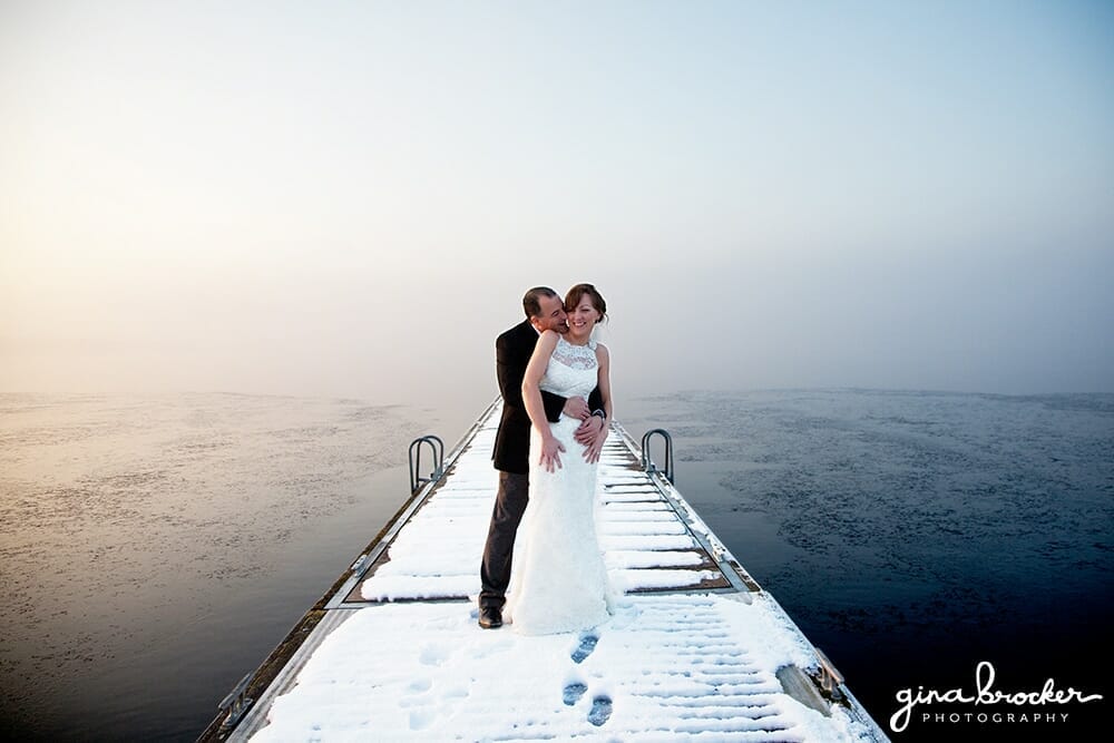 Bride and Groom cuddle in the snow during a winter wedding