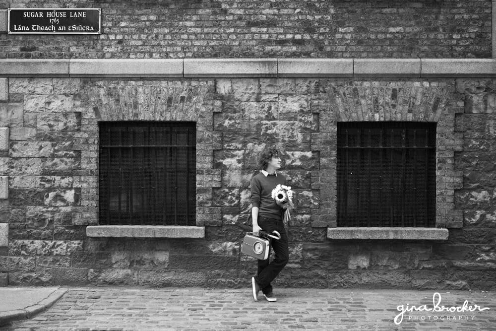 Husband waiting with flowers in Boston during a sweet love story session 
