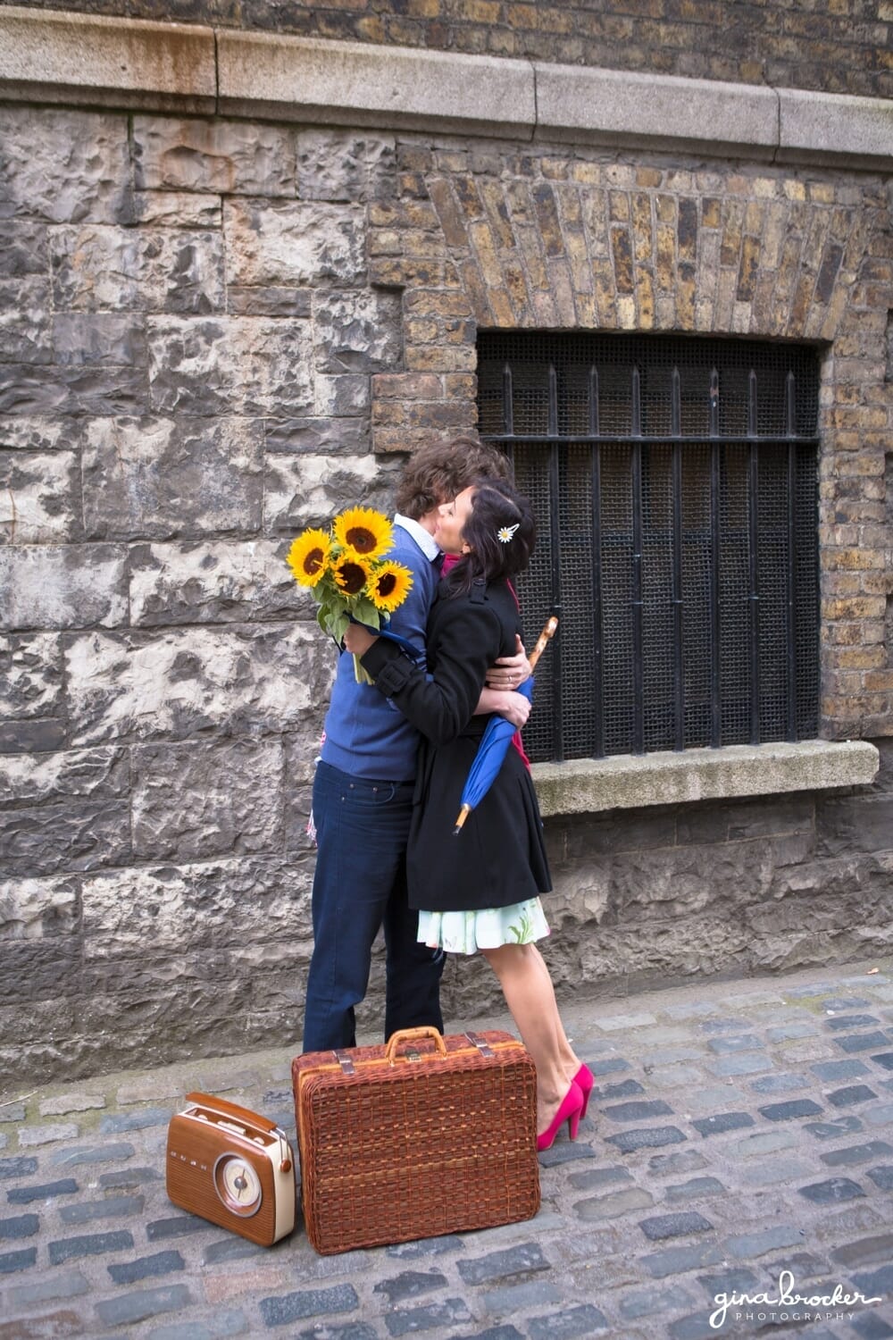 Husband and wife hug when the meet for their picnic love story session in the city
