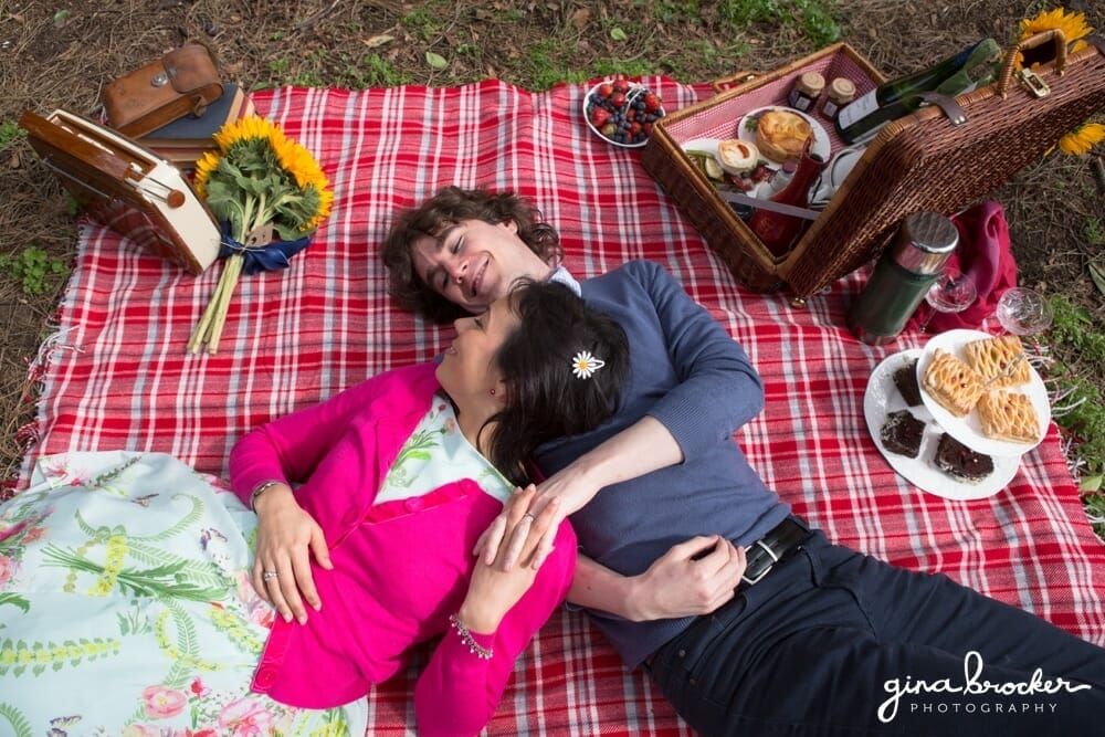 Couple lay together on blanket during a rustic picnic shoot in Boston Common