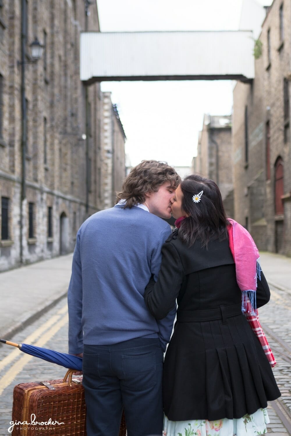 A couple kisses in the city during their relaxed and rustic love story session