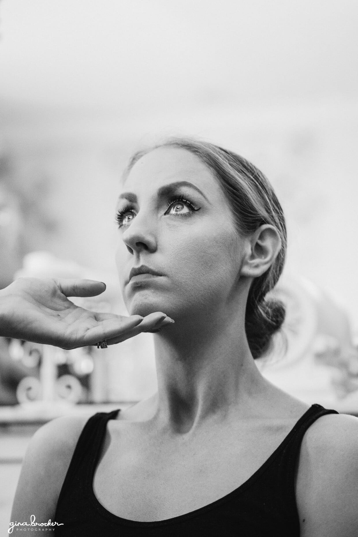 bride gets her makeup done on the morning of her wedding