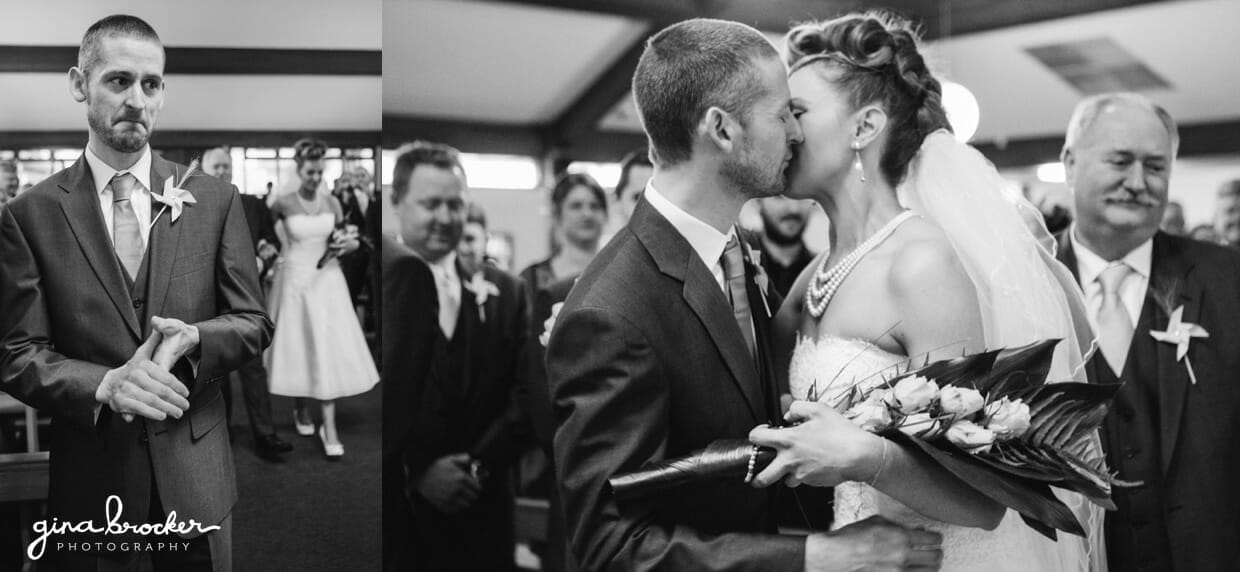 The groom waits for the bride to walk up the aisle before giving her a kiss