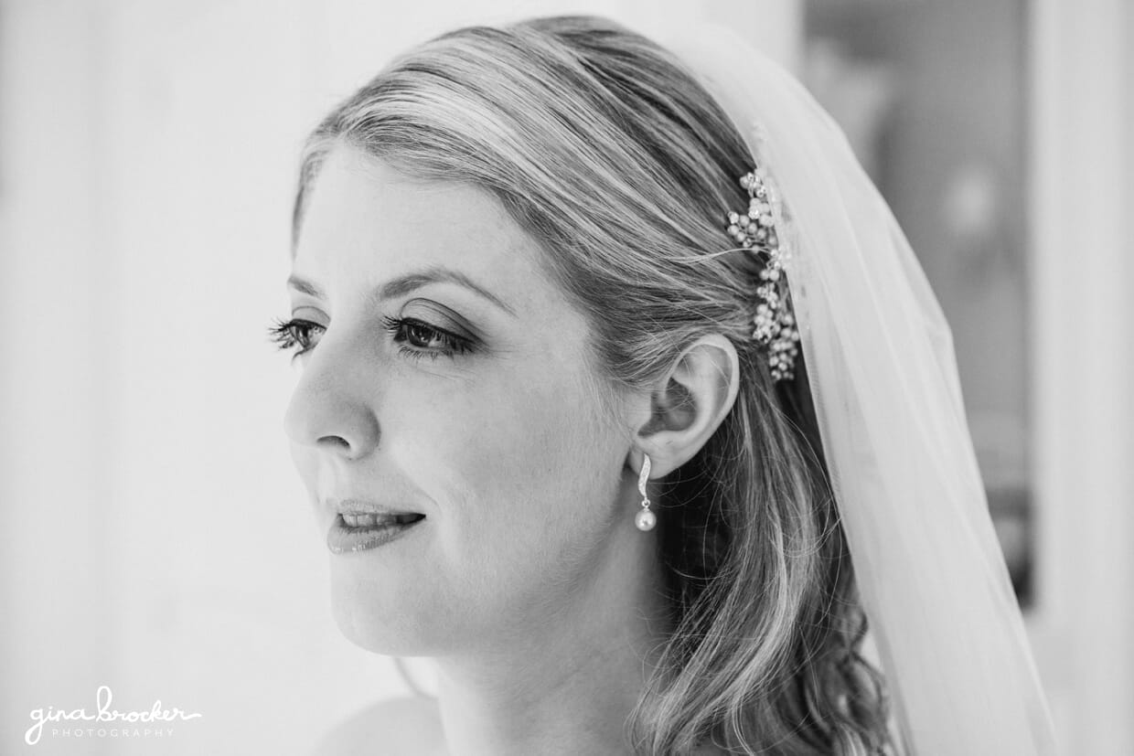 A portrait of a classic vintage bride with delicate lace veil and ornate headpiece before she leaves for her wedding ceremony