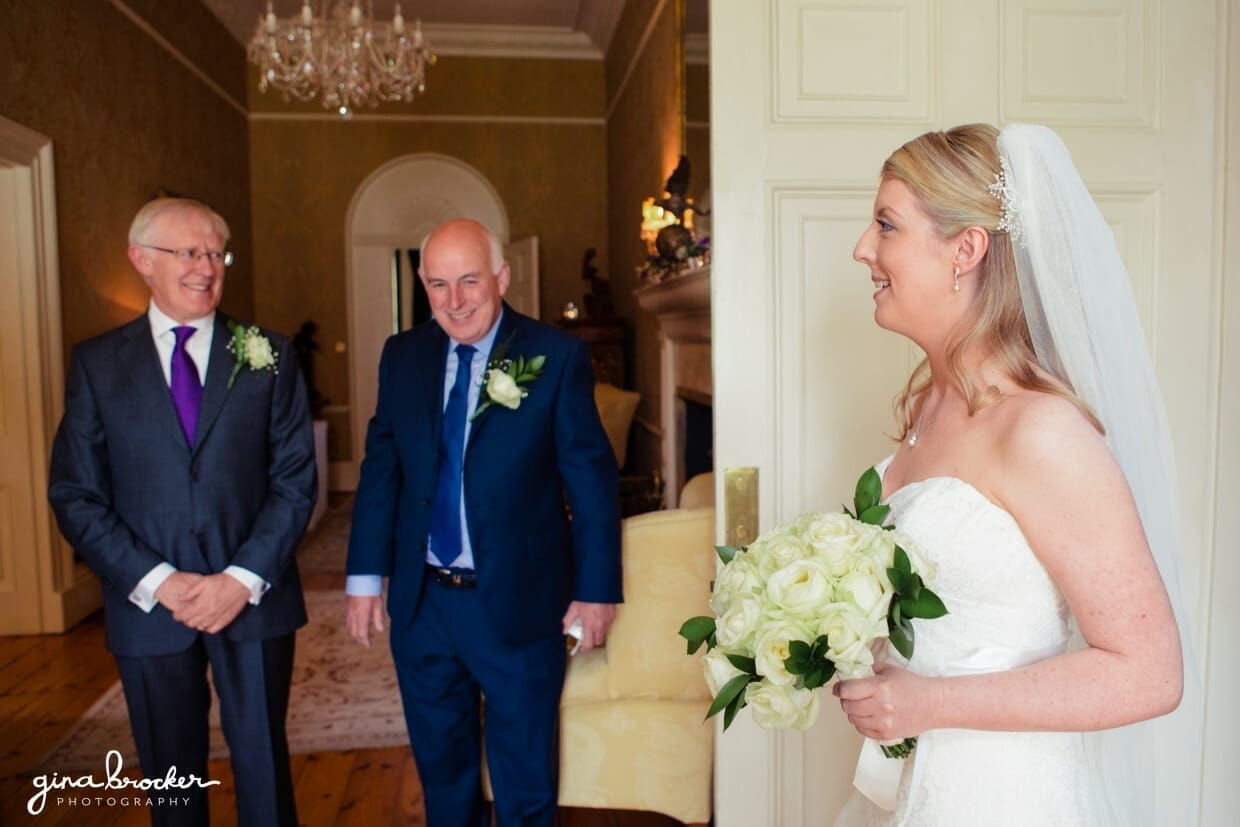 bride-leaving-for-ceremony The father of the bride smiles when he sees his beautiful daughter as a bride
