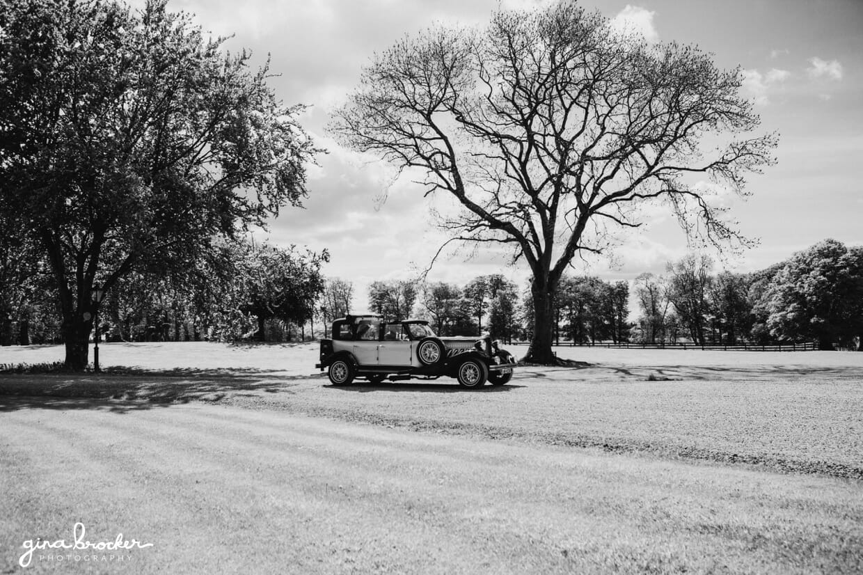 A vintage and classic wedding car take the bride and her father to an intimate wedding ceremony in a church