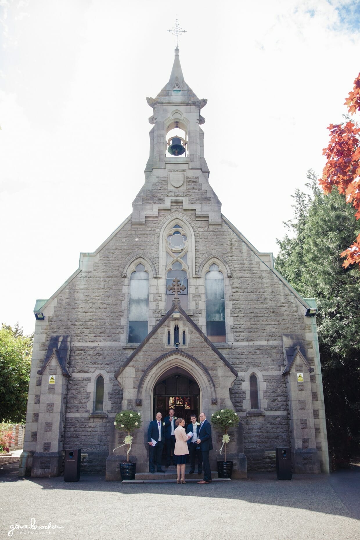 The groom greets guests as the arrive to a small and quaint church for an intimate wedding ceremony