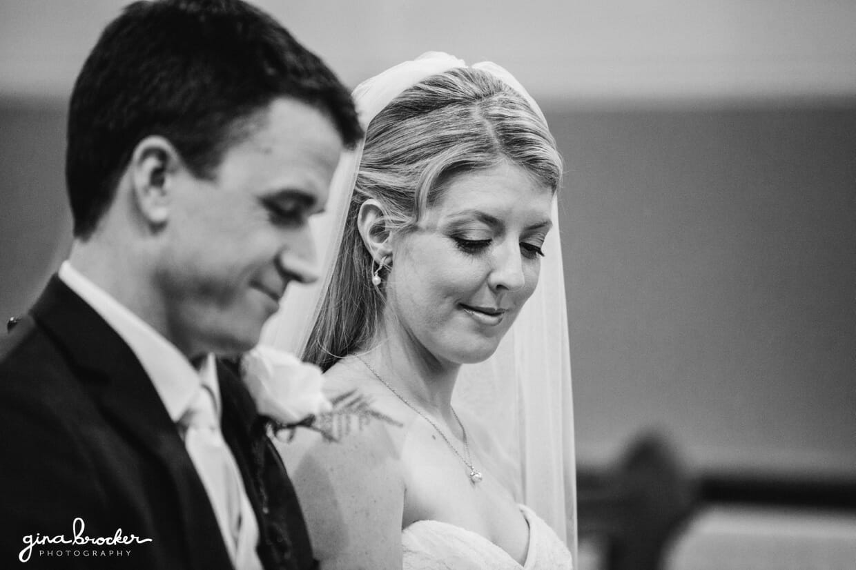 The bride and groom read a prayer from their mass booklets during their intimate catholic wedding ceremony