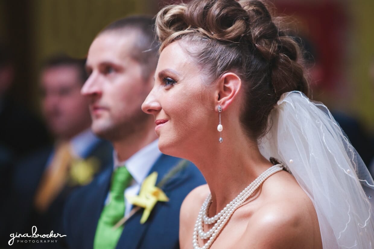 21.retro.bride.and.groom.in.ceremony bride smiles during the wedding ceremony