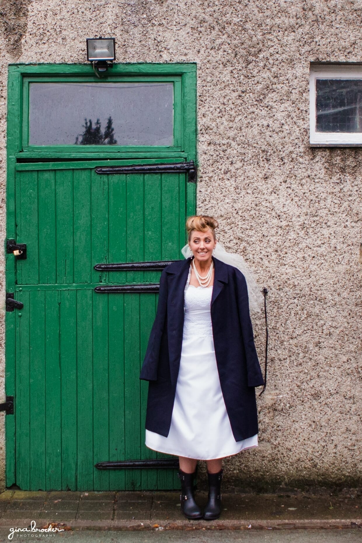 A fun portrait of a retro bride wearing the grooms jacket