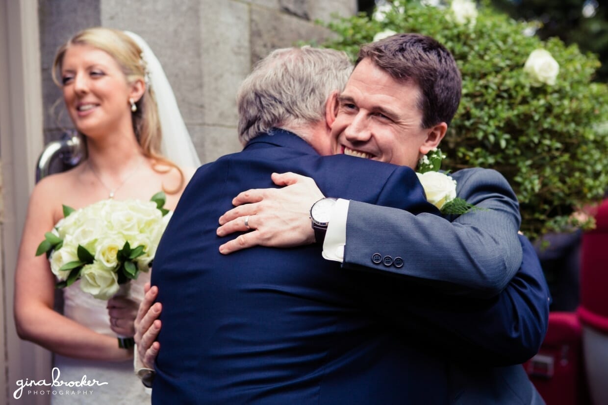 groom.hugs.guests The groom hugs his guests during the reception line following their intimate wedding ceremony