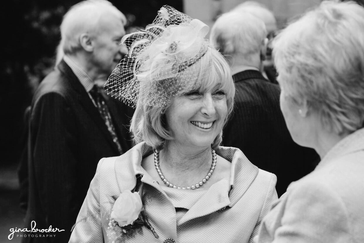 candid.wedding.photographs The mother of bride laughs while she talks to her friend at a classic vintage wedding