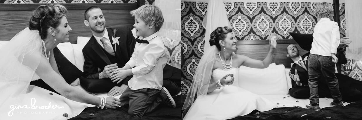 The bride and groom spend a few moments having fun with their son during their fun wedding
