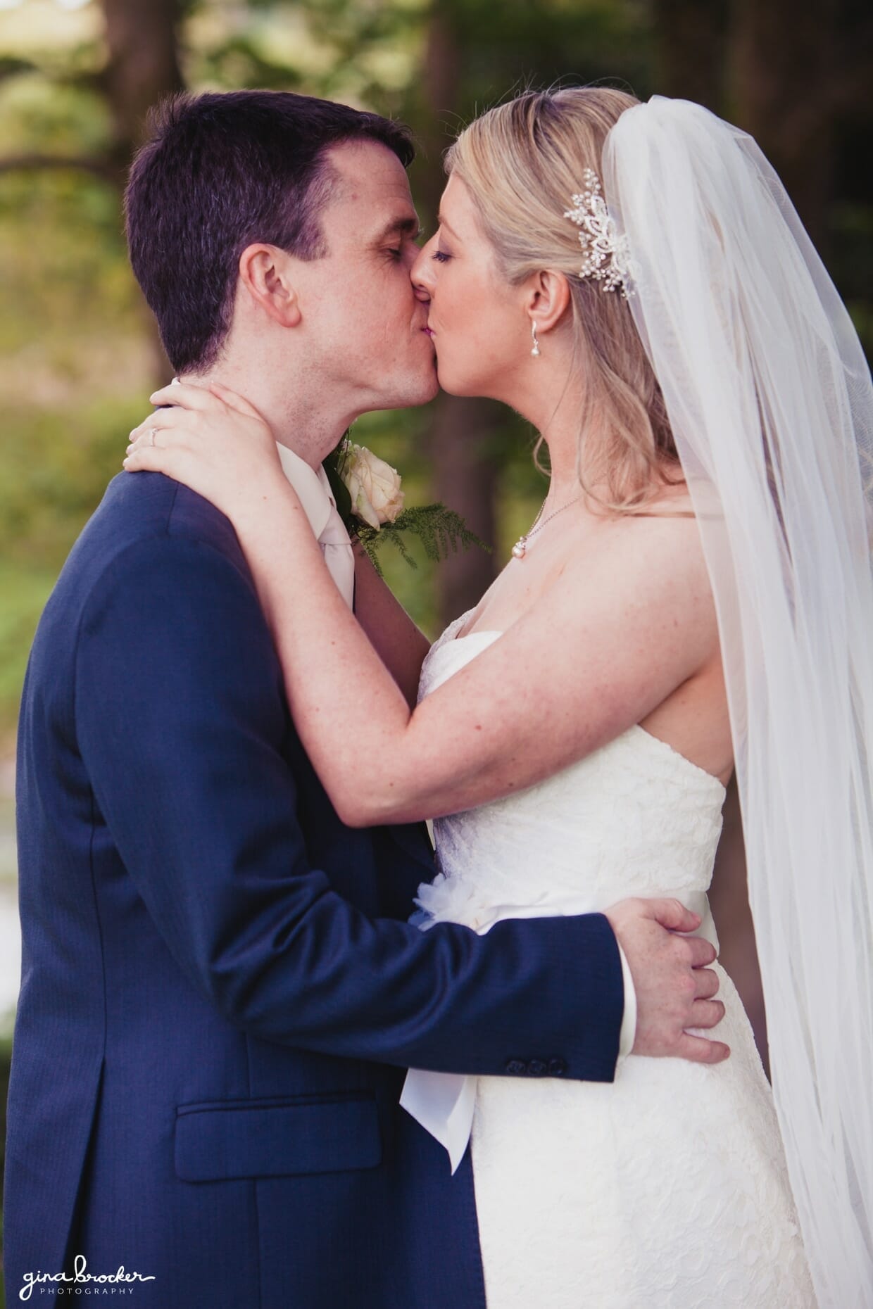 wedding-portrait-kiss The bride and groom kiss in the woods after their beautiful wedding ceremony