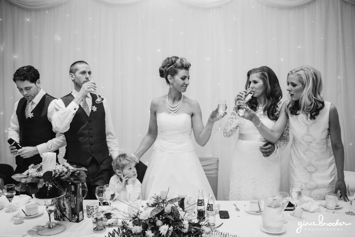 The bride and groom celebrate their fun and retro wedding with a toast