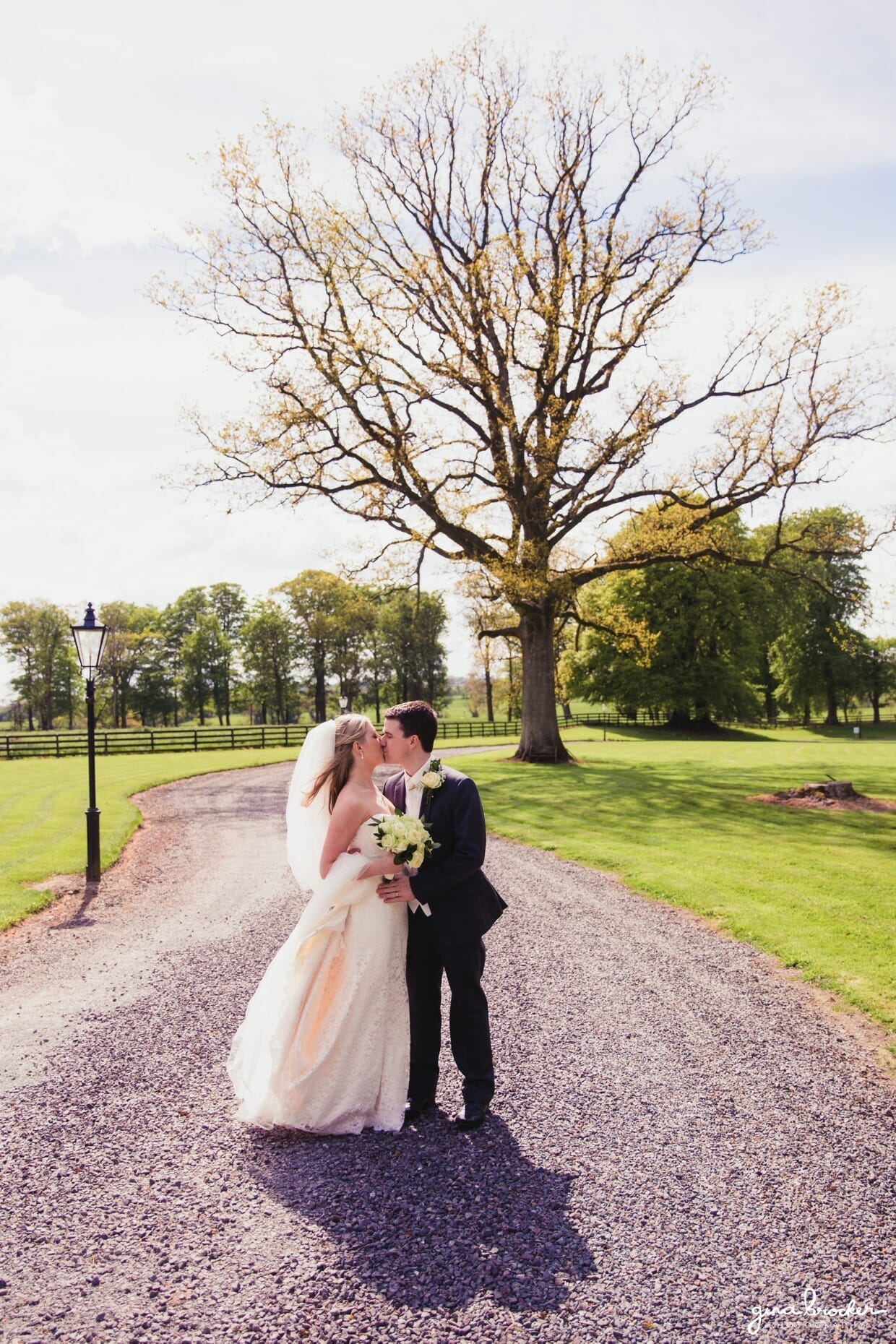 The bride and groom share a kiss during their classic vintage wedding