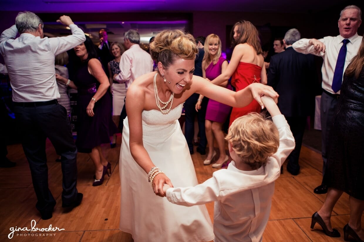 The bride has a great time dancing with her son at their fun wedding full of retro style