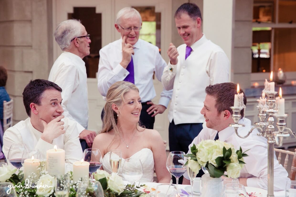 bride-and-groom-talking-to-guests A candid photograph of the bride and groom talking with their guests during their intimate wedding reception