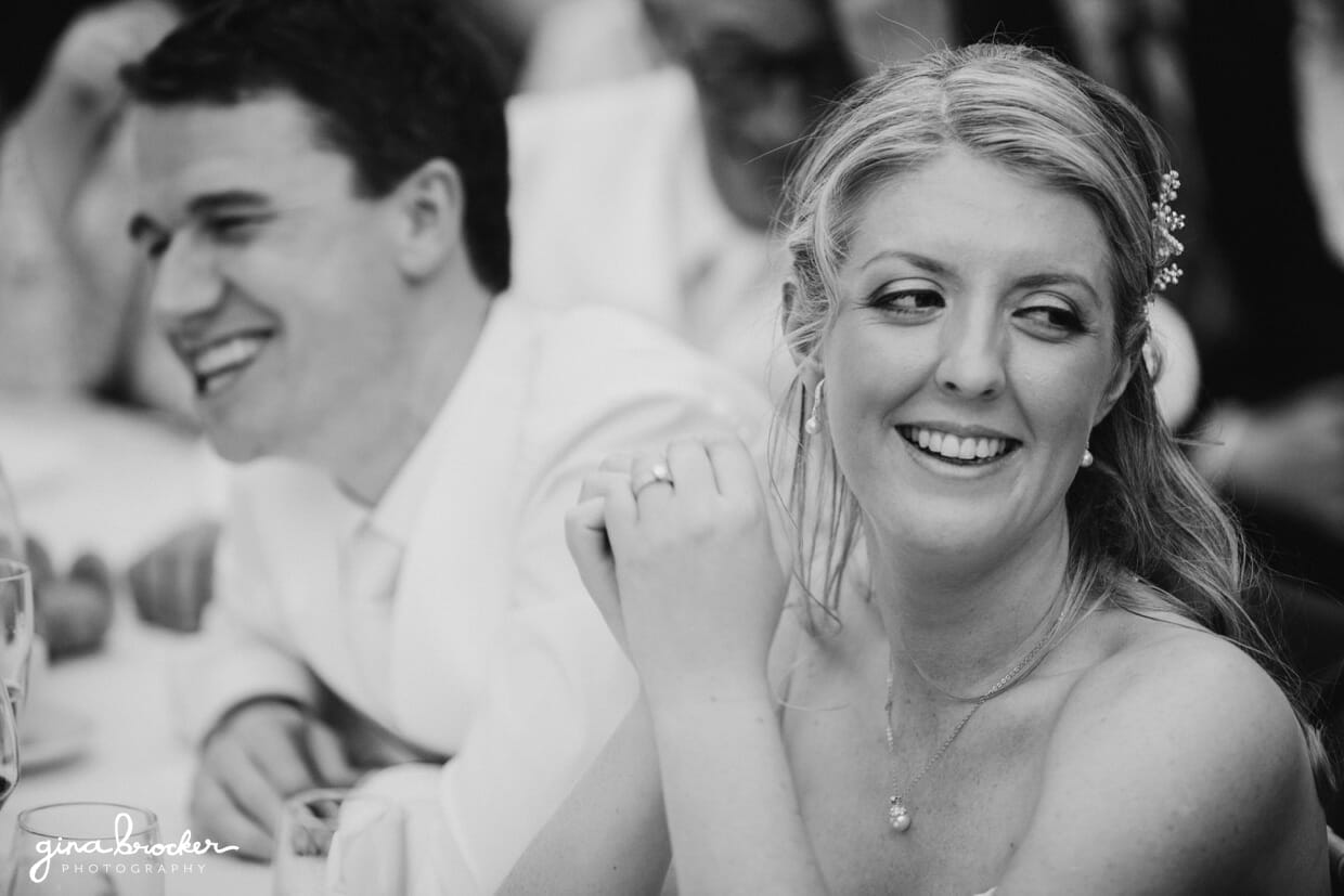 bride-laughing-during-wedding-toasts The bride and groom laugh during the best man's funny wedding toast