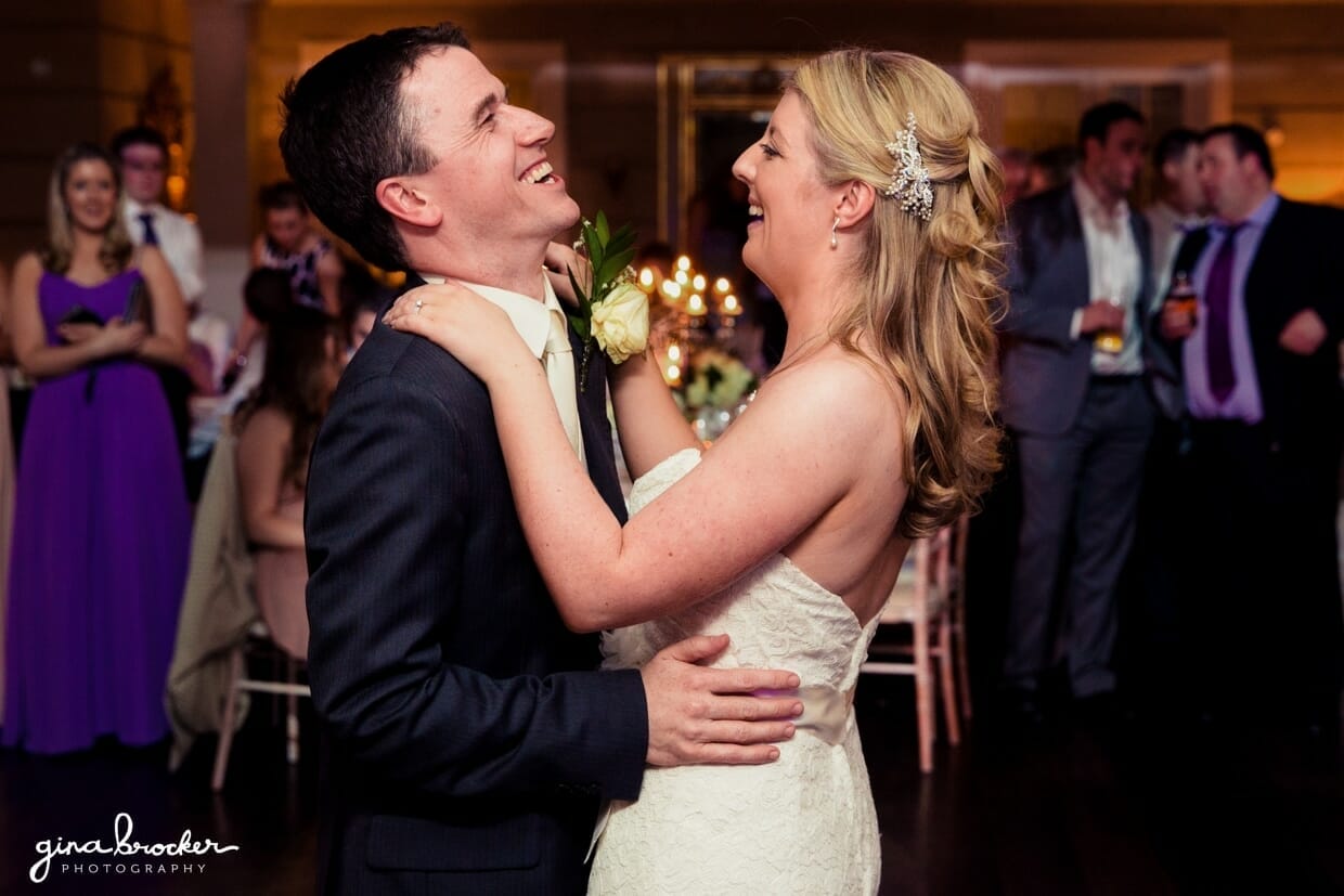 The bride and groom laugh as they share their first dance as husband and wife