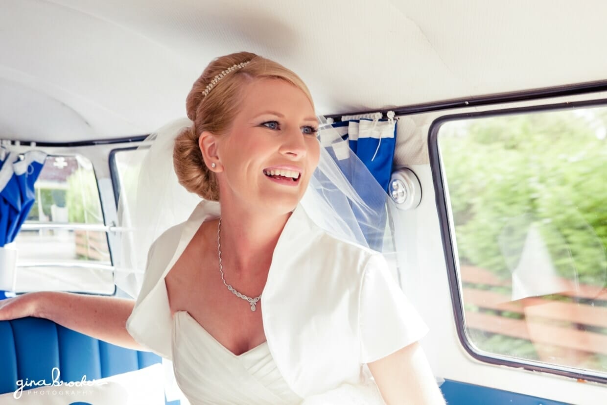 10.bride.in.blue.vw.bus A bride smiles on the way to the church in a blue retro volkswagen bus