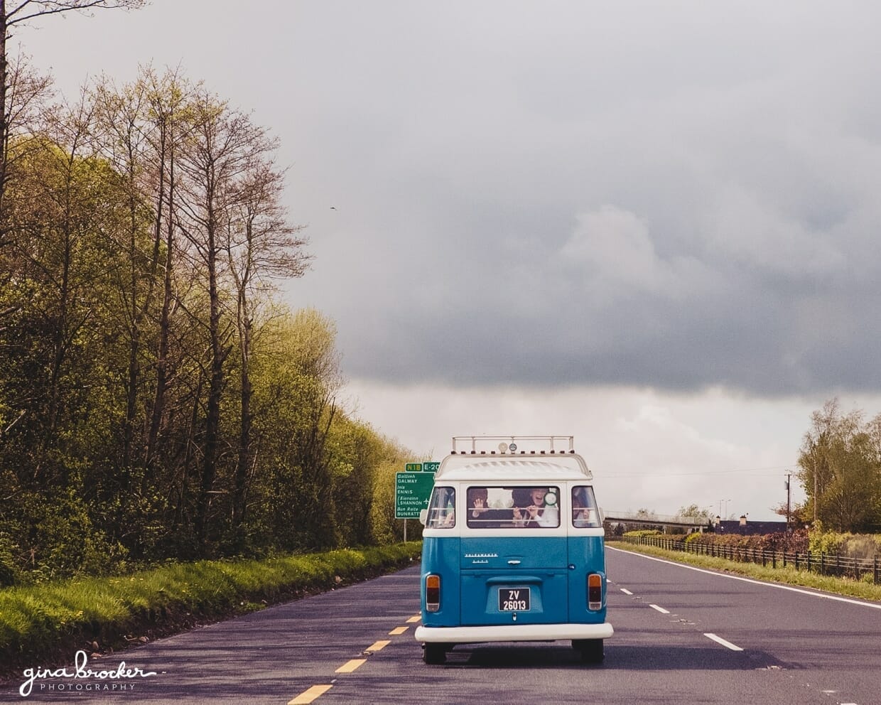 11.blue.vw.bus.for.wedding A blue retro volkswagen bus drives the wedding party to the church