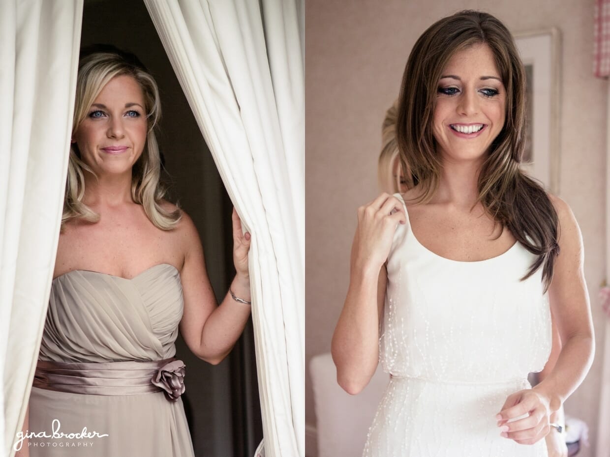 A bridesmaids smiles at the bride as she gets into her simple and elegant wedding dress