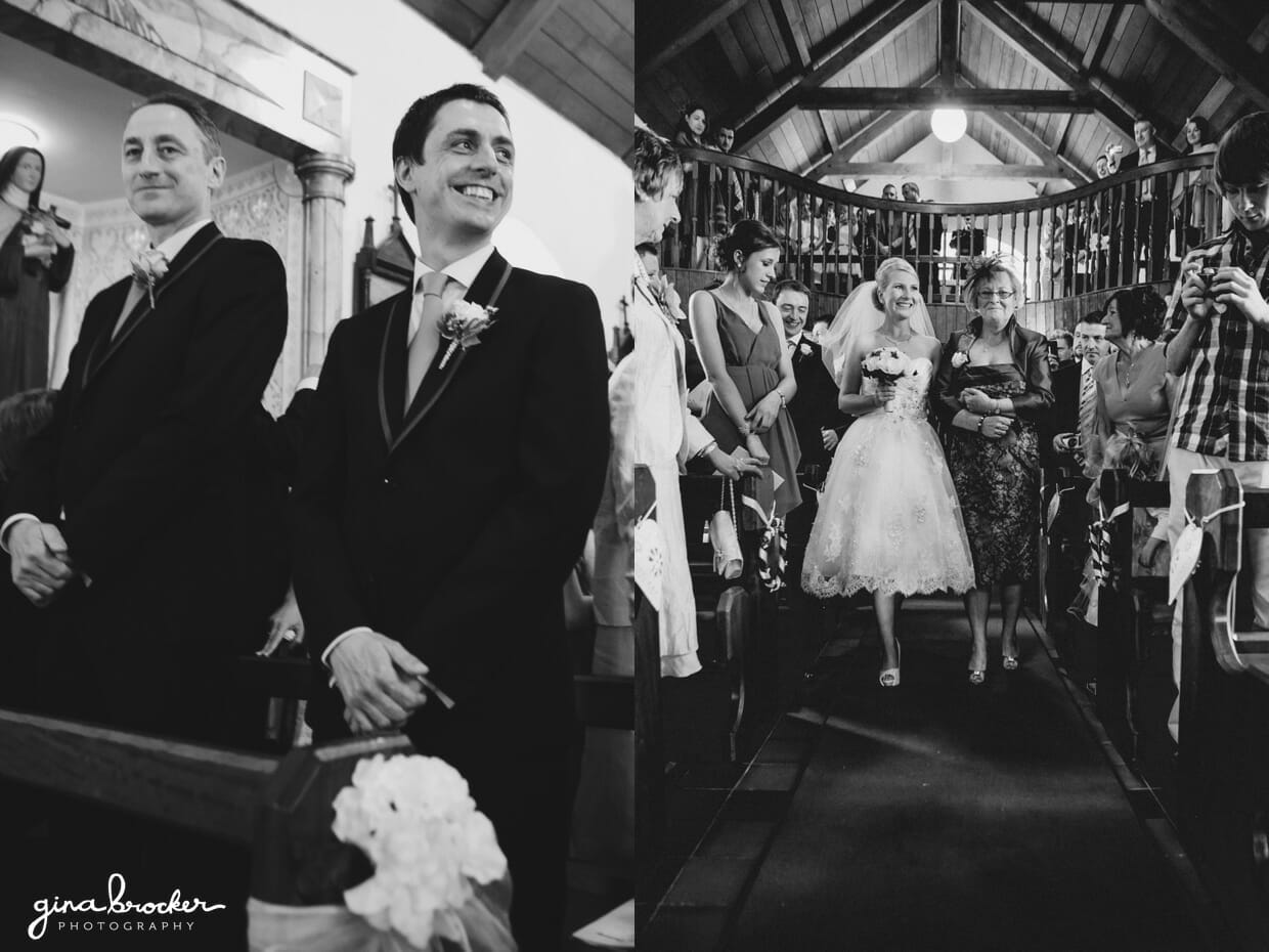 The groom smiles as his bride walks down the aisle during their sweet church wedding ceremony