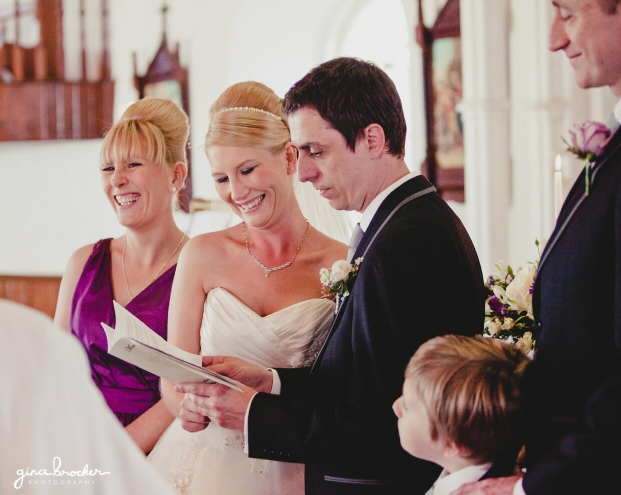 19.groom.says.wedding.vows The bride and her bridesmaid smile while groom says his vows during their wedding ceremony is a small church