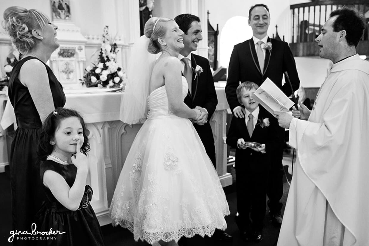 20.funny.moment.during.wedding.vows The wedding party laugh during an intimate wedding ceremony in a small church