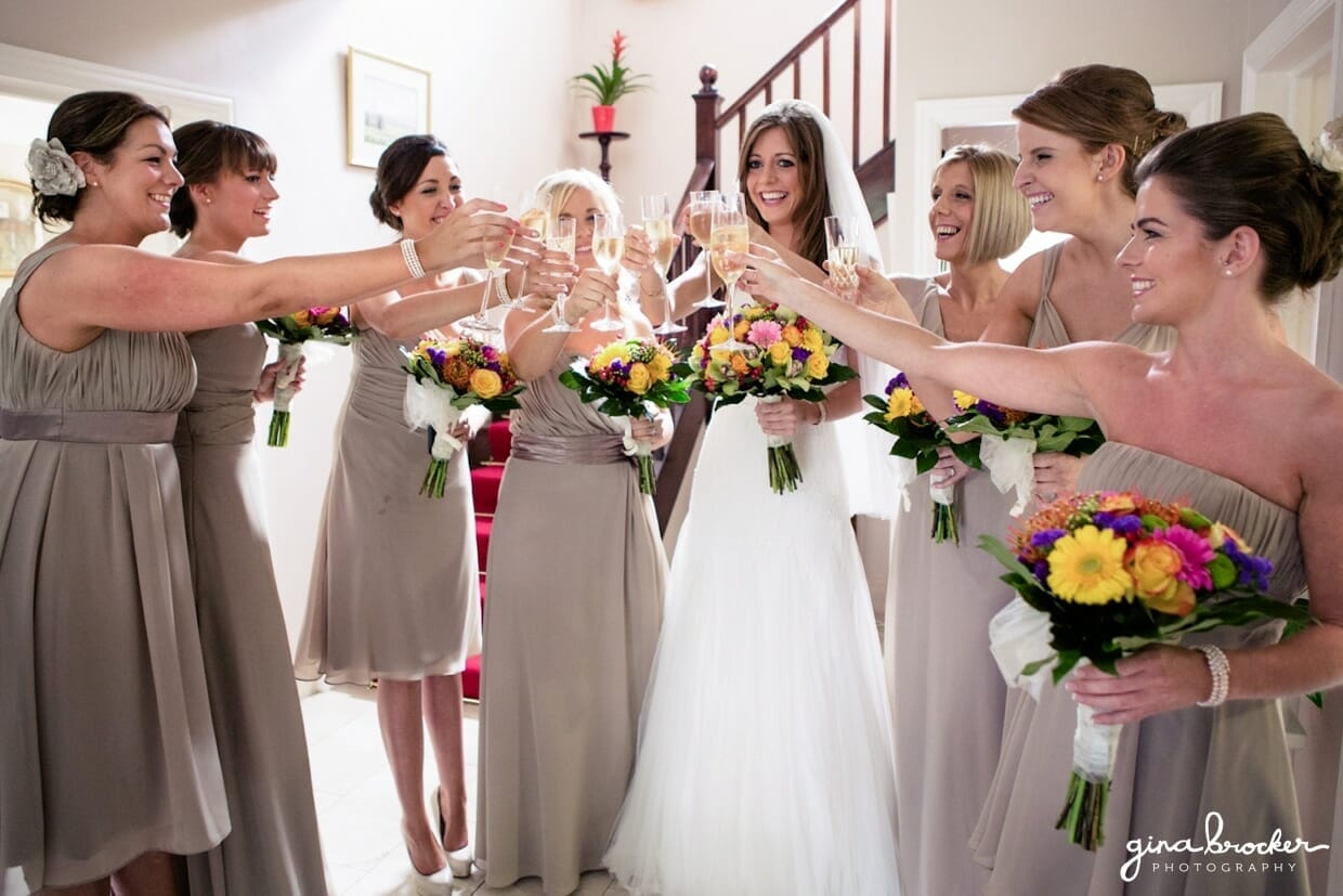 The bride and her bridesmaids make a toast on the morning of her colorful and elegant wedding