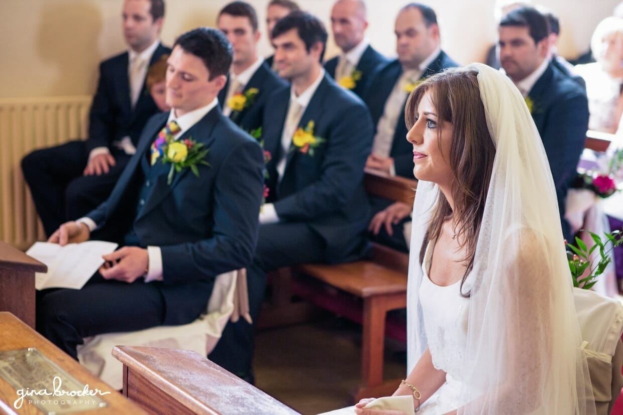 The bride and groom focus on the priests words during their personal wedding ceremony in a small church