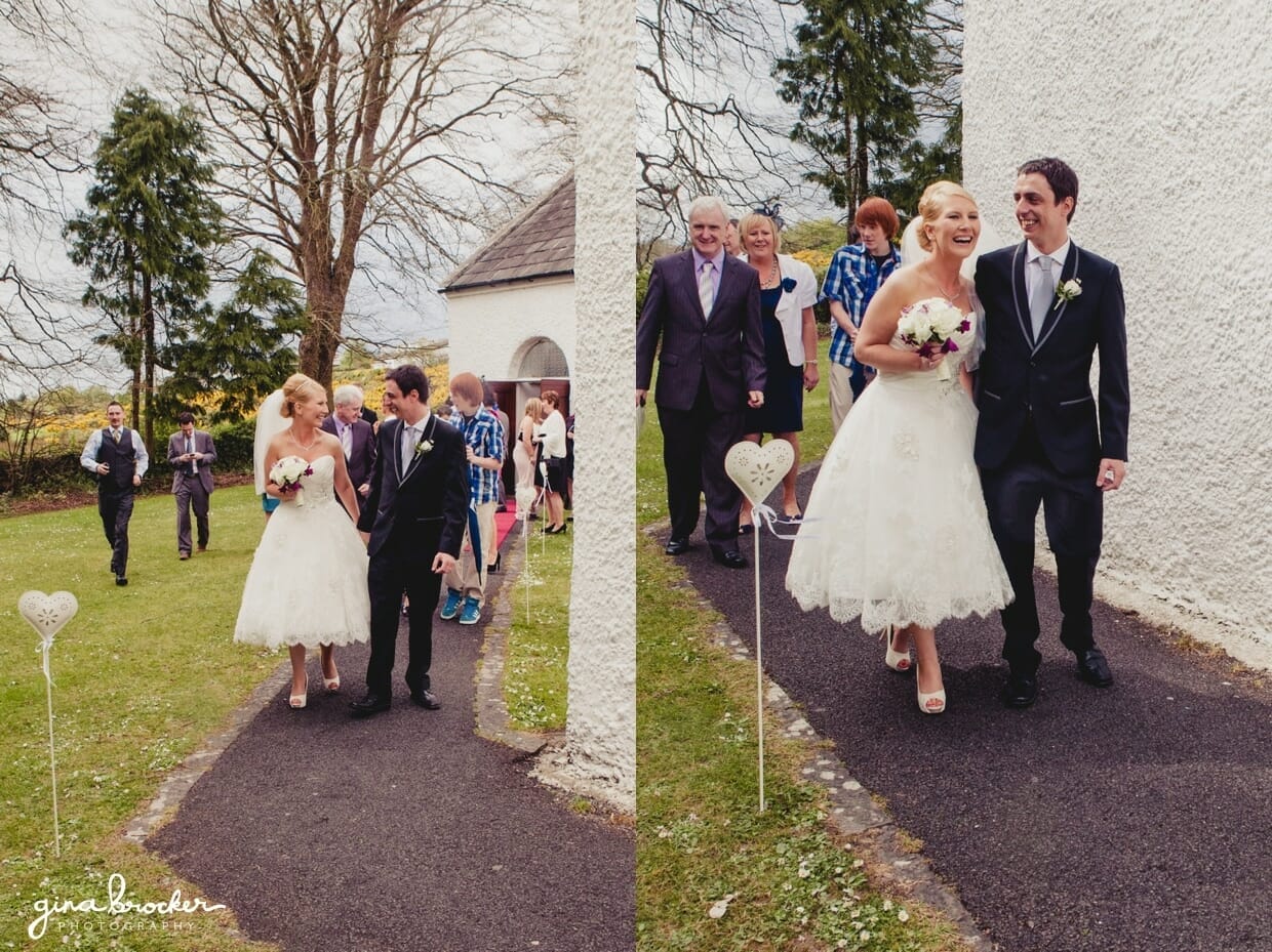 The bride and groom walk together out of the church after their intimate wedding ceremony