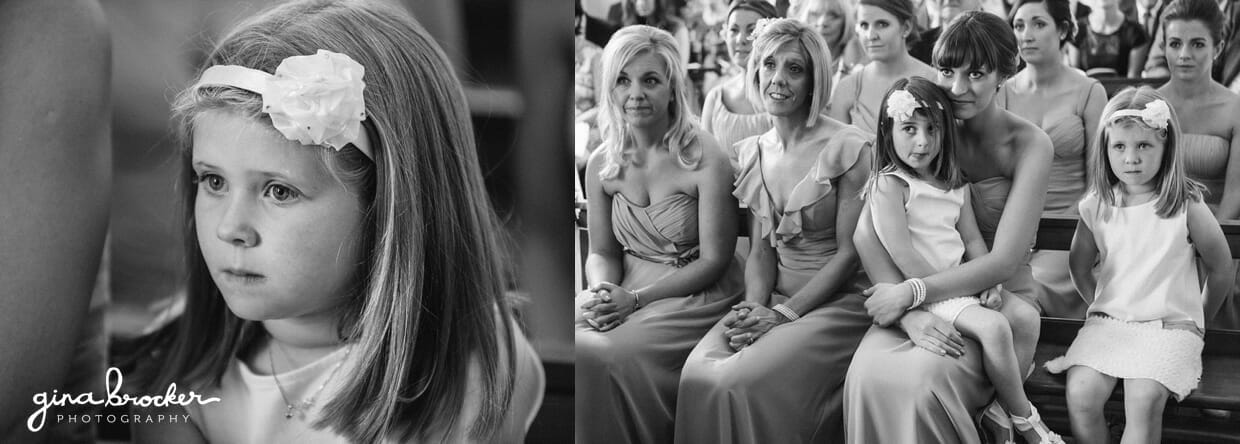 The flower girls sit with the bridesmaids during an intimate wedding ceremony in a small church
