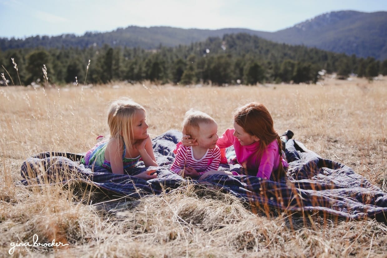 33.girls.on.blanket.outside Three girls lay on a blanket and talk during an outdoor kids session