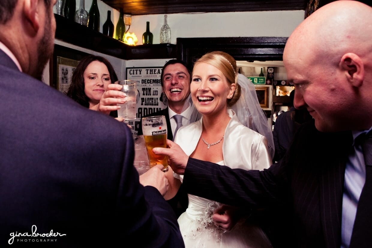 The bride and groom talk with guests during their vintage inspired cocktail hour