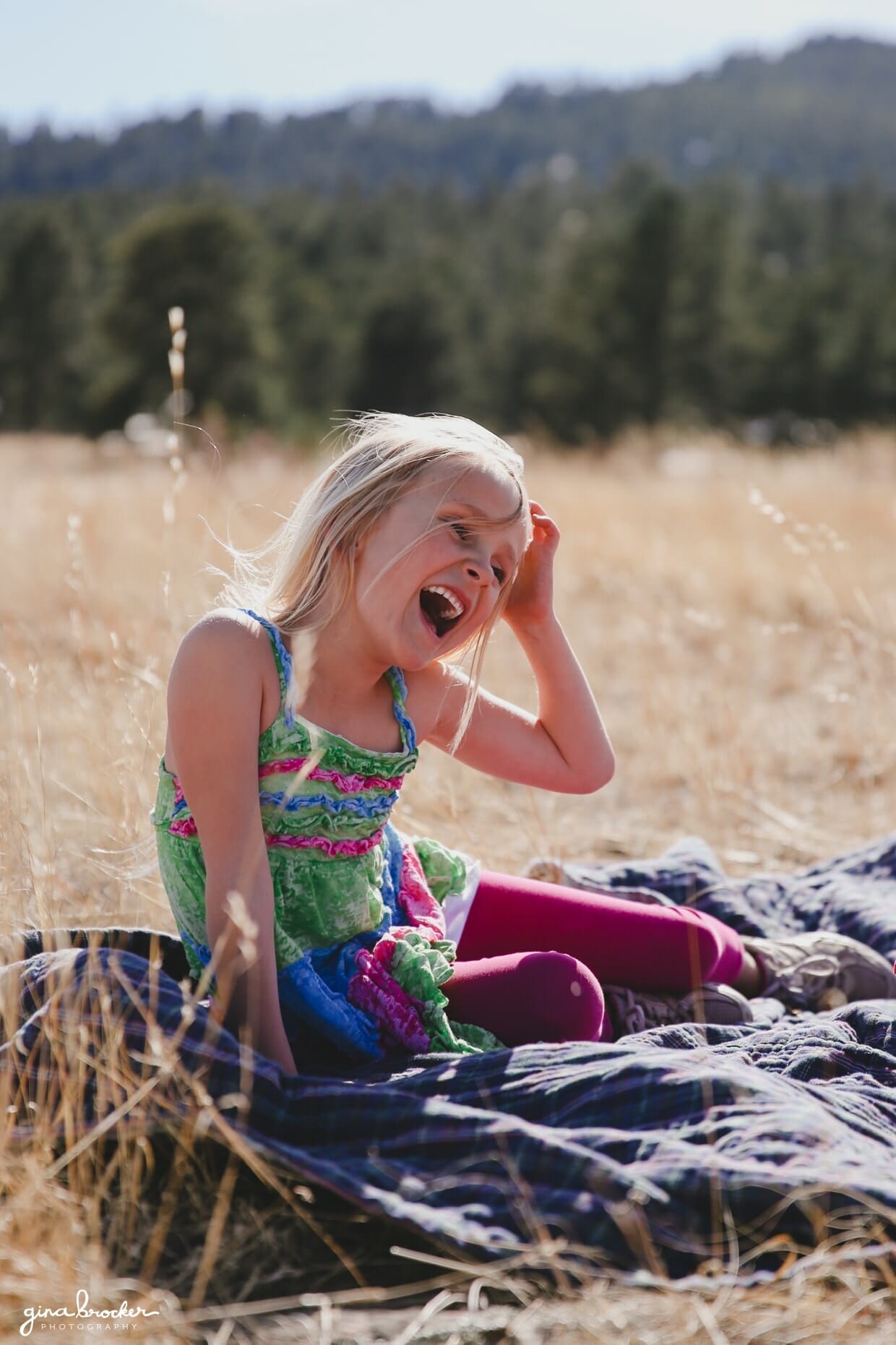 A portrait of a little girl laughing during a family photo session in Boston, Massachusetts