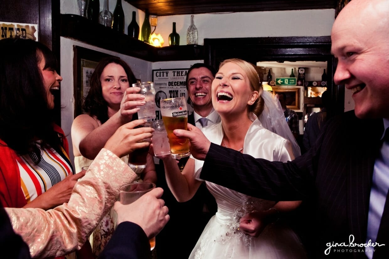 The bride and groom laugh with guests during their vintage inspired cocktail hour 